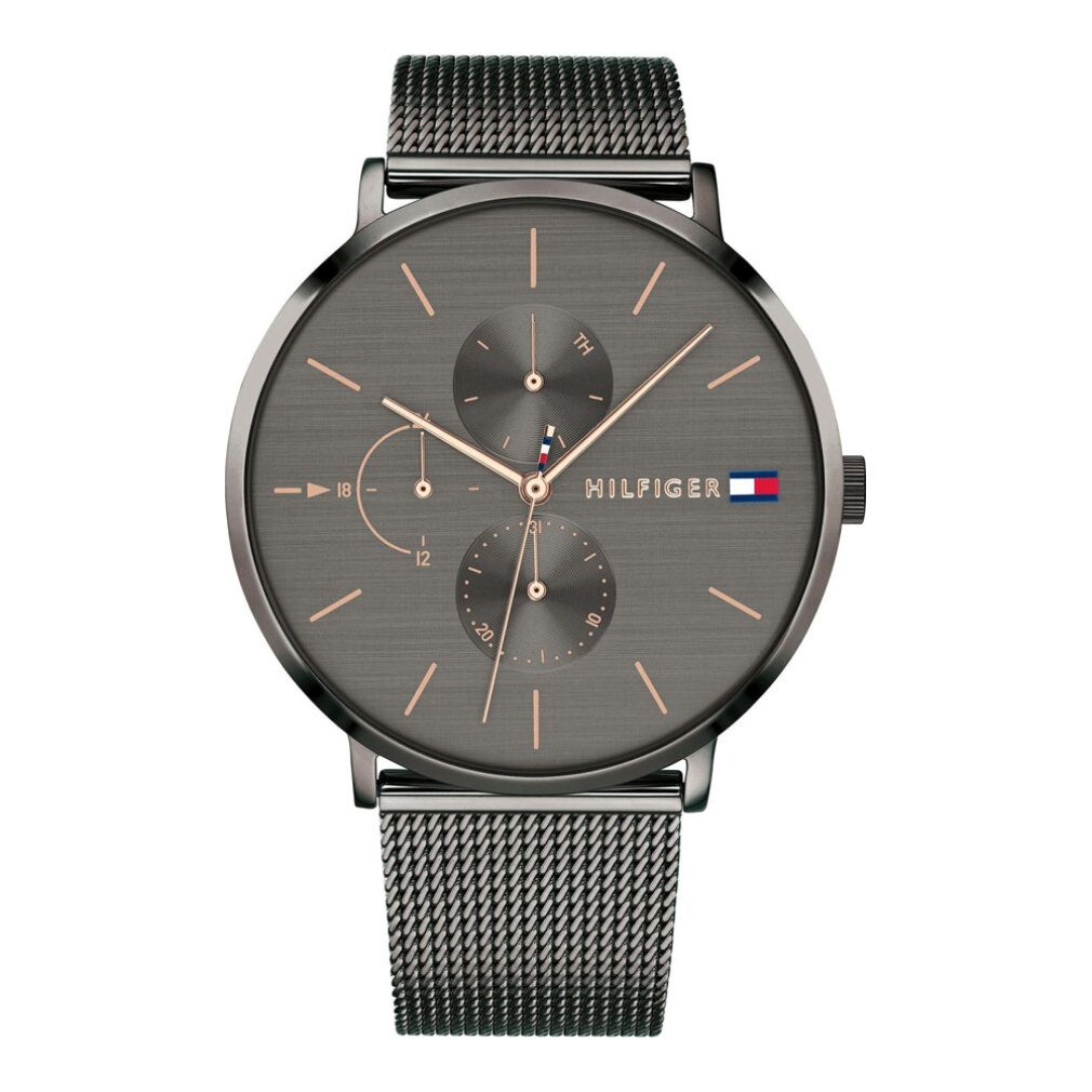 Orologio grigio con lancette oro rosa e cinturino a maglia. Logo Hilfiger e tre quadranti secondari.