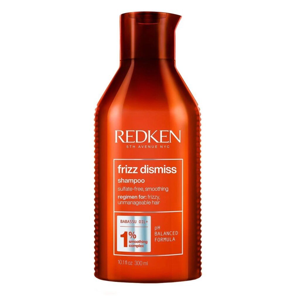 Flacone rosso di shampoo Redken Frizz Dismiss. Testo: Frizz Dismiss, Shampoo, formula pH bilanciata, 1% Smoothing Complex.