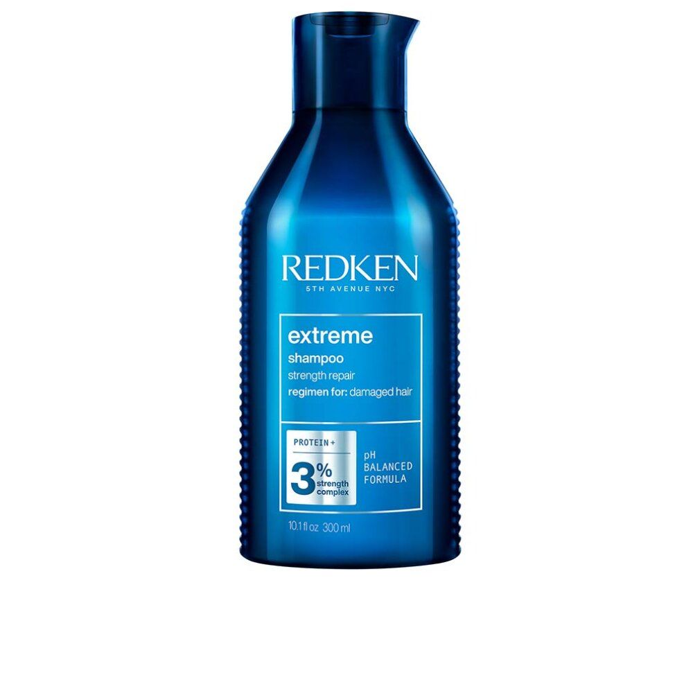 Flacone di shampoo blu scuro. Scritta: Redken, extreme shampoo, 3% strength complex, pH balanced formula. 300ml.