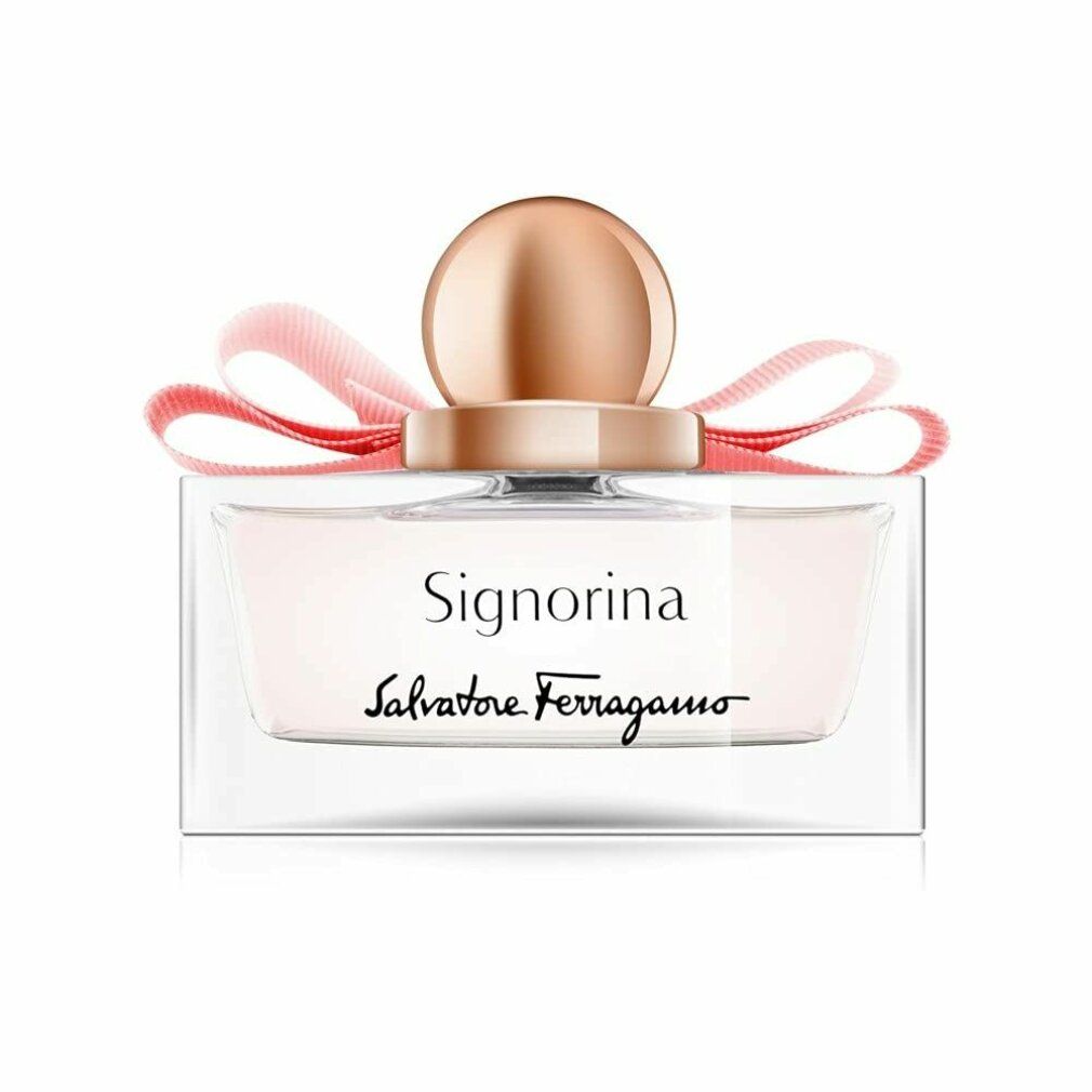 Flacone di profumo con liquido rosa, tappo dorato e fiocco rosa. Scritta Signorina e Salvatore Ferragamo.