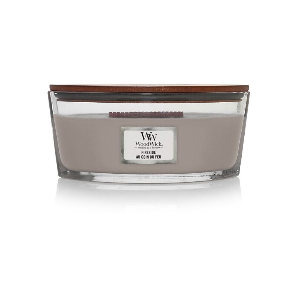 Candela ellittica con coperchio in legno. Etichetta 'WoodWick' e 'Fireside'. Cera grigia.