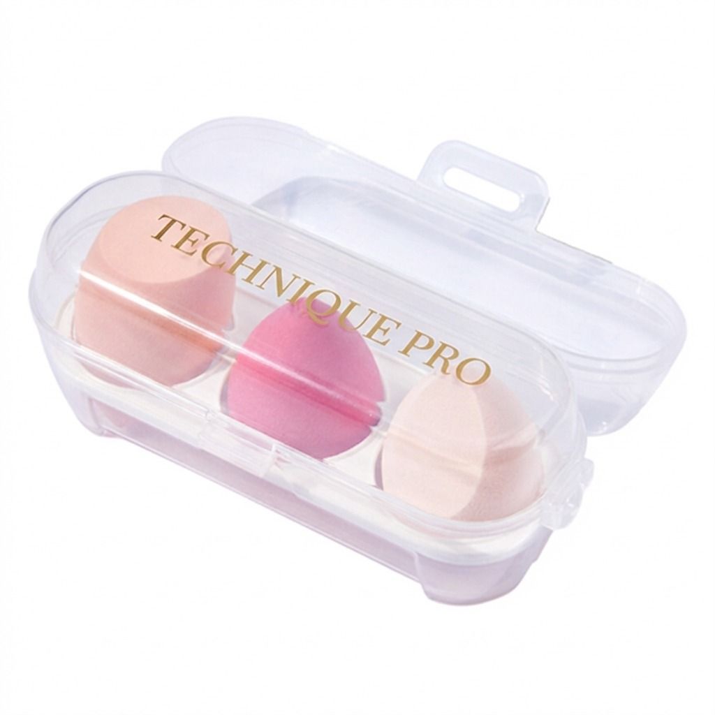 Tre spugnette da trucco rosa e pesca in un astuccio da viaggio trasparente con la scritta "TECHNIQUE PRO".
