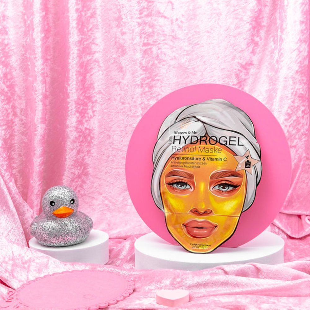 Confezione del prodotto su sfondo rosa. Scritta: Sisters & Me, maschera Hydrogel Retinol. Illustrazione: donna con maschera.