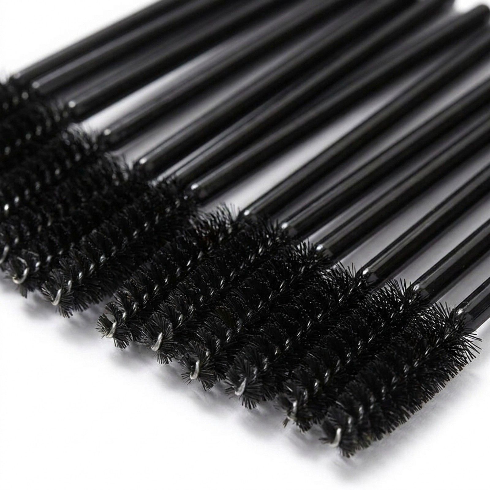Primo piano delle testine di scovolini per ciglia neri con setole fini e anelli metallici.