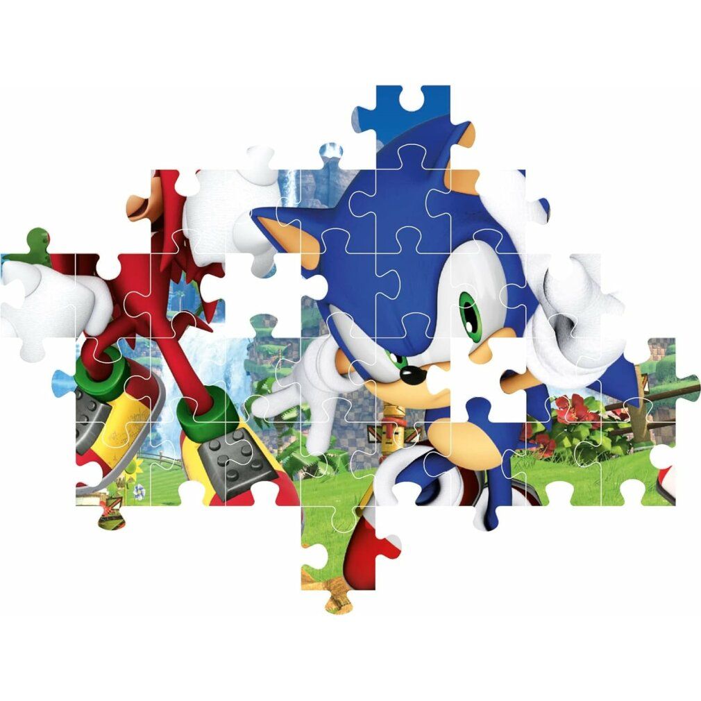 Pezi di puzzle con motivo Sonic. Personaggi: Sonic, Knuckles, Amy. Pezzi parzialmente assemblati. Sfondo: paesaggio.