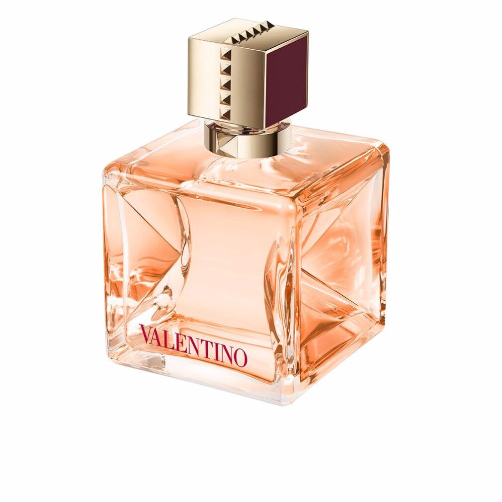 Flacone di profumo quadrato con tappo dorato. Scritta: Valentino. Liquido rosa.