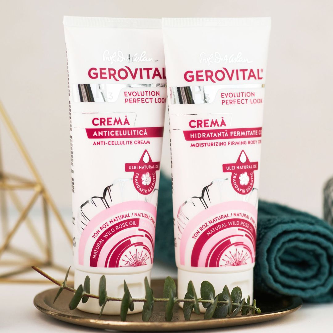 Due tubi di crema Gerovital. Etichette rosa e bianche. Su un vassoio con asciugamano e ramo.