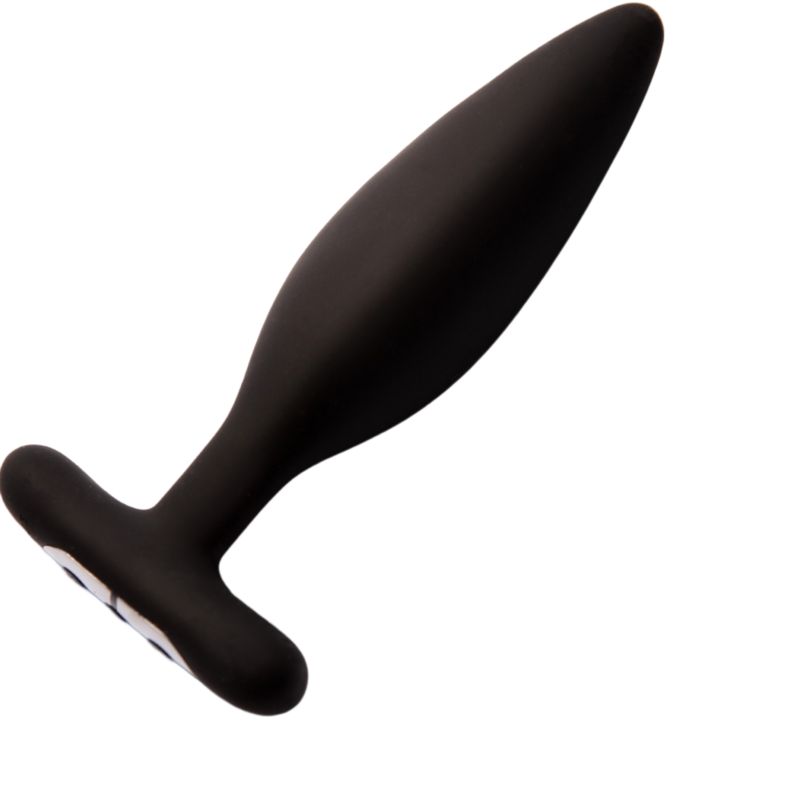 Plug anale nero, forma affusolata con base a T. Superficie liscia. Sfondo bianco.