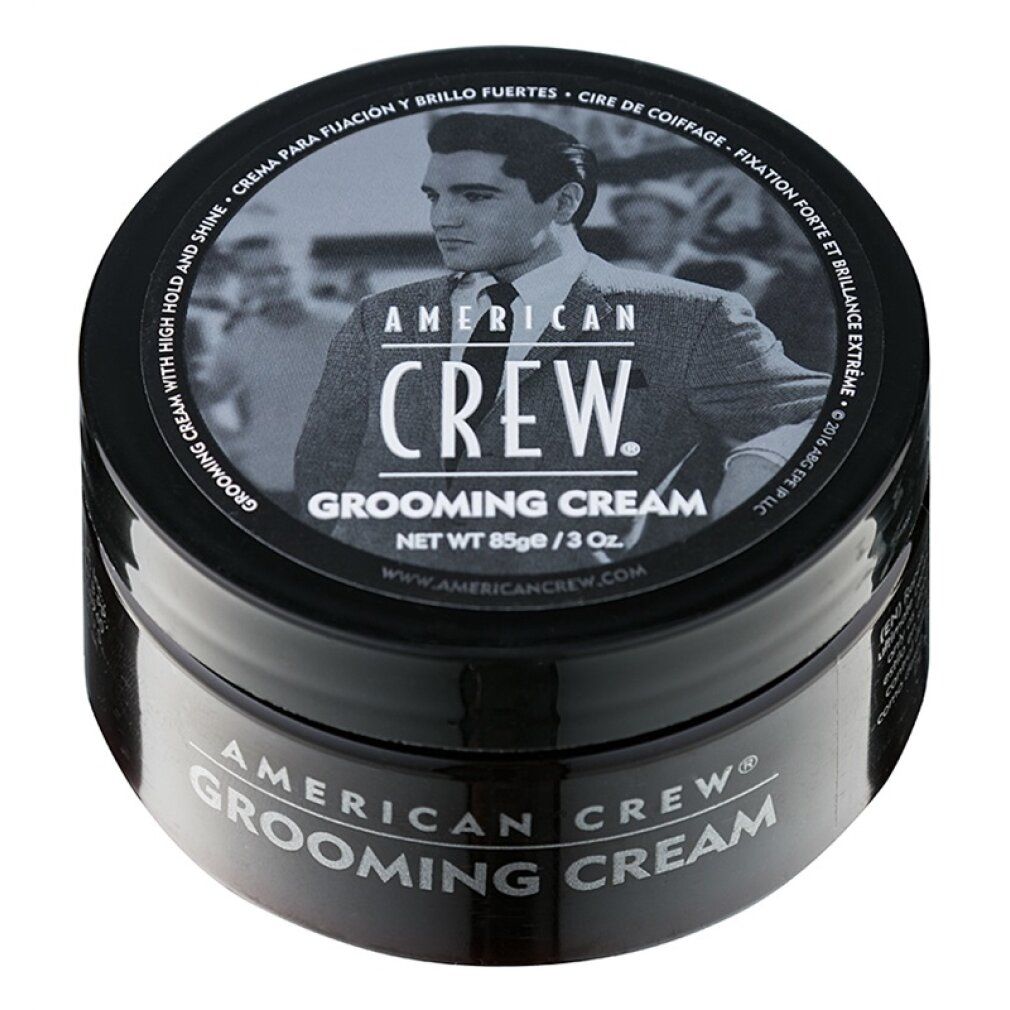 Barattolo nero American Crew Grooming Cream. Coperchio con immagine e testo. Nome del prodotto e marchio sul contenitore.