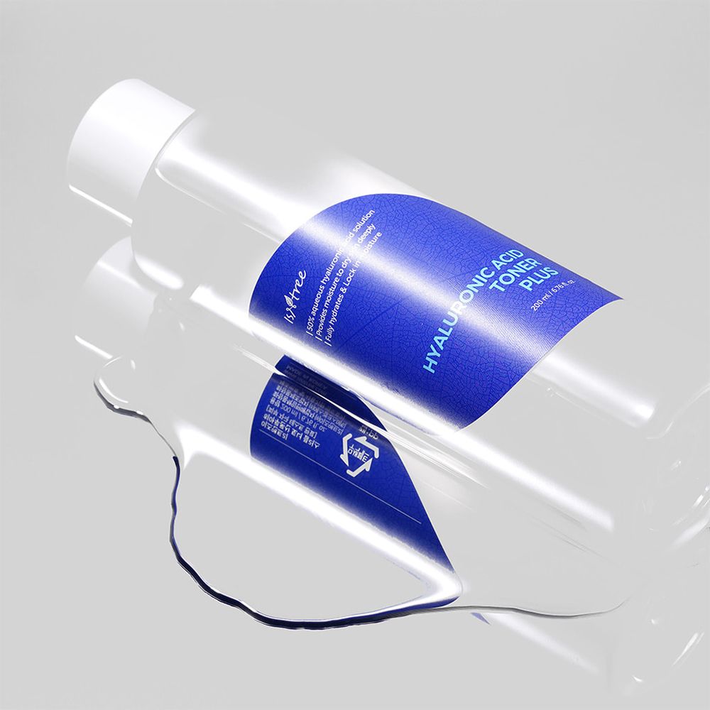 Flacone trasparente con etichetta blu. Scritta: Hyaluronic Acid Toner Plus. Liquido su superficie liscia.