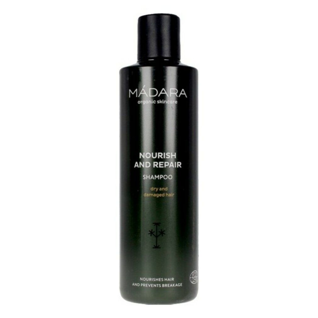 Flacone di shampoo verde scuro con tappo nero. Scritta: MÁDARA, Nourish and Repair Shampoo, per capelli secchi e danneggiati.
