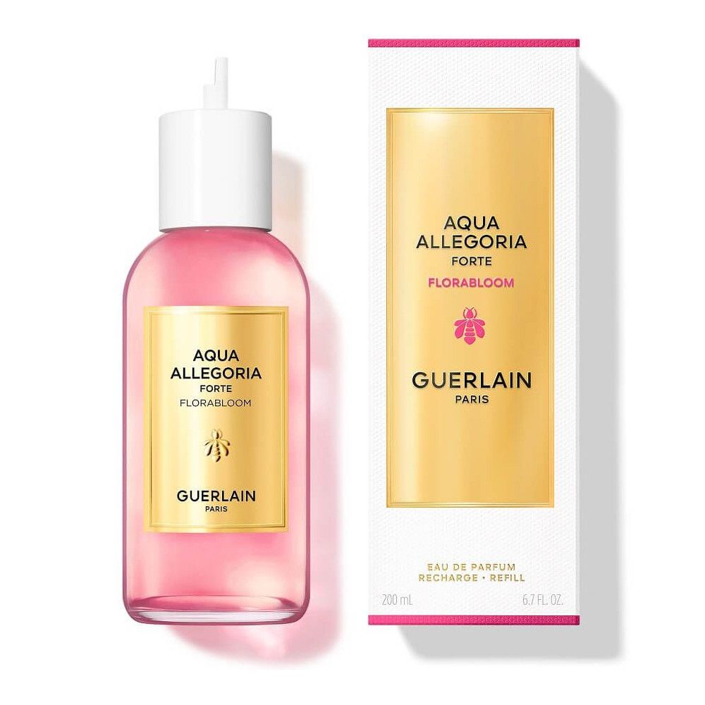 Flacone di liquido rosa con tappo bianco, accanto a confezione bianca. Etichetta dorata con testo: Aqua Allegoria Forte Florabloom, Guerlain Paris.