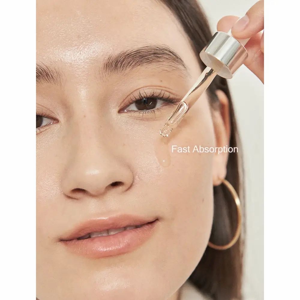 Donna con applicatore di siero. Scritta: Fast Absorption. Orecchino dorato.