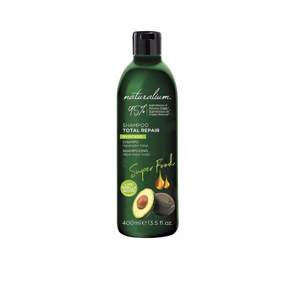 Flacone di shampoo verde con tappo nero. Illustrazione di avocado e scritta 'Super Food'. Testo: 'Shampoo Total Repair'.