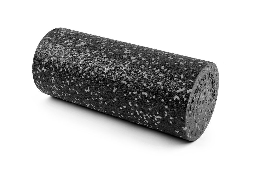 Rullo per fascia cilindrico nero con punti bianchi. Su sfondo bianco.