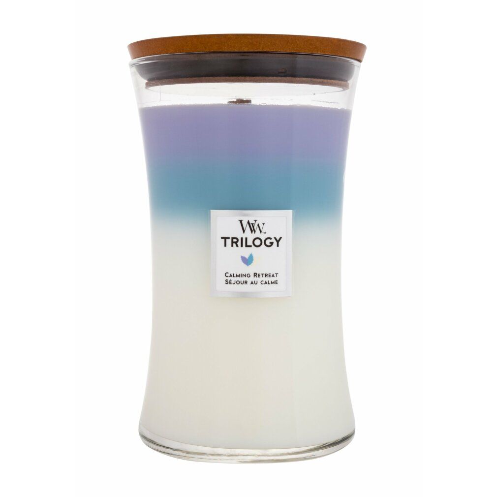 Candela profumata con coperchio in legno. Tre zone di colore: bianco, blu e viola. Etichetta con logo e testo. Contenitore di vetro.