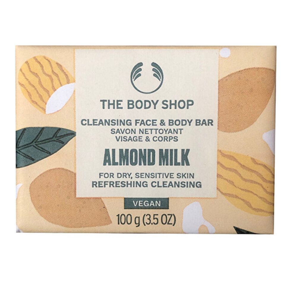 Panetto di sapone in confezione di carta. Scritta: The Body Shop, Cleansing Face & Body Bar, Almond Milk, Vegan. 100 g.