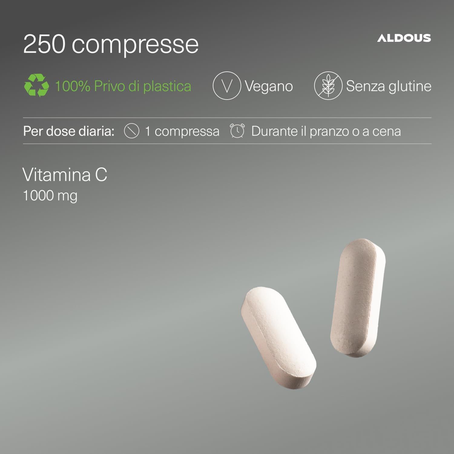 Aldous Vitamina C 1000mg: Compressa non rivestita tenuta da una mano. Lattina sullo sfondo. Informazioni su dosaggio e ingredienti.