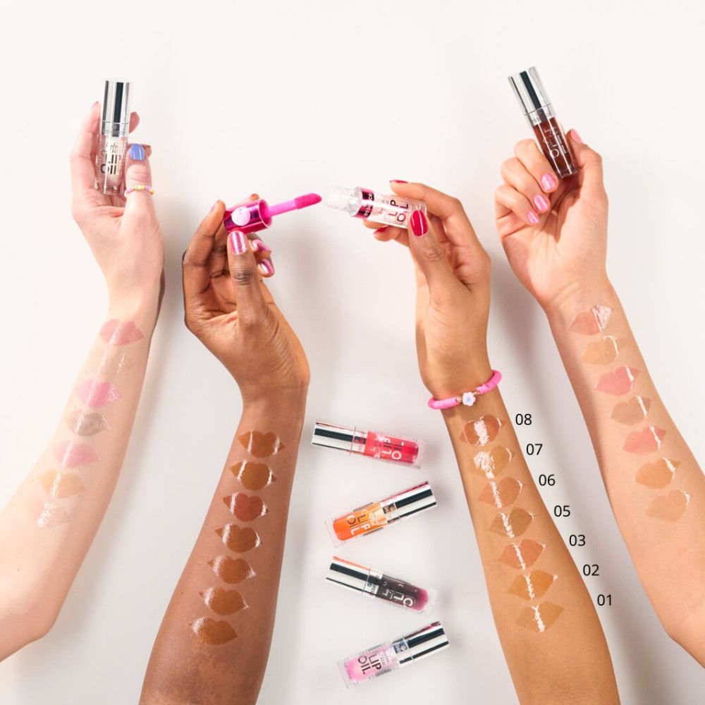 Diverse braccia con campioni di lucidalabbra in vari colori. Sui bracci sono visibili dei numeri.