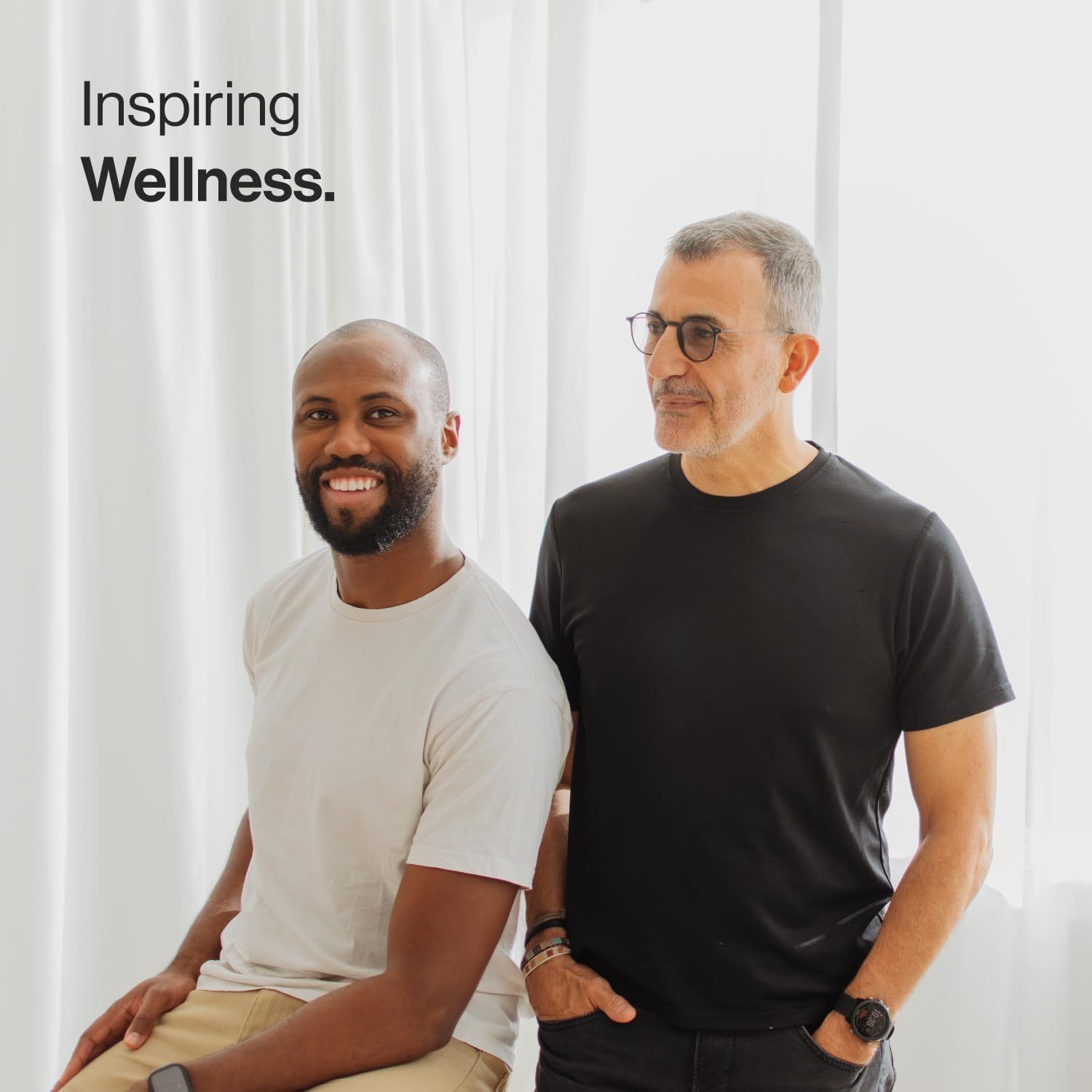 Due uomini. Testo: Inspiring Wellness.