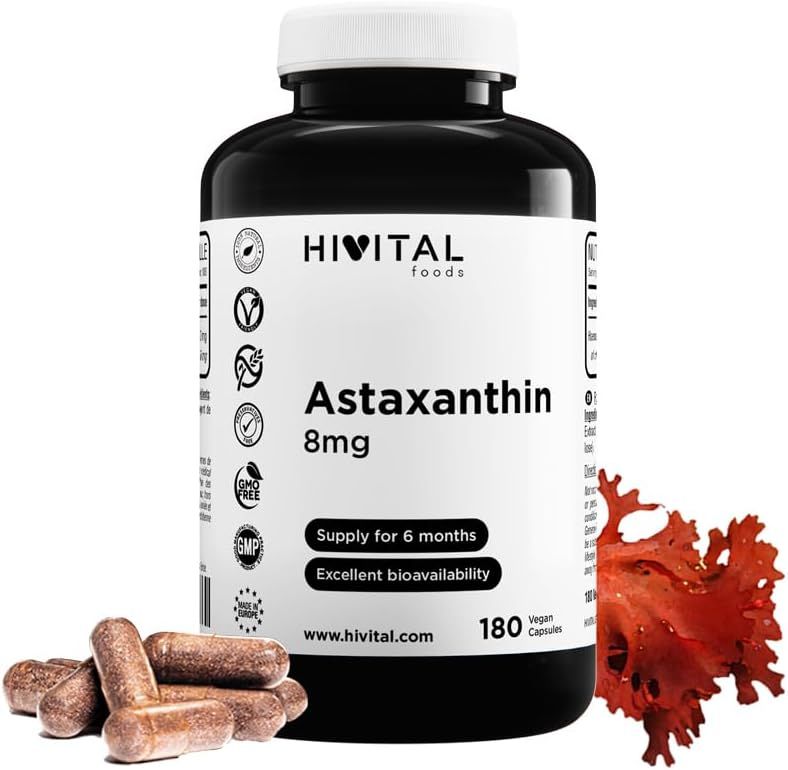 Capsule marroni vicino a un flacone nero con etichetta bianca. Scritta: Hivital Astaxantina 8mg. Vegano, 180 capsule.