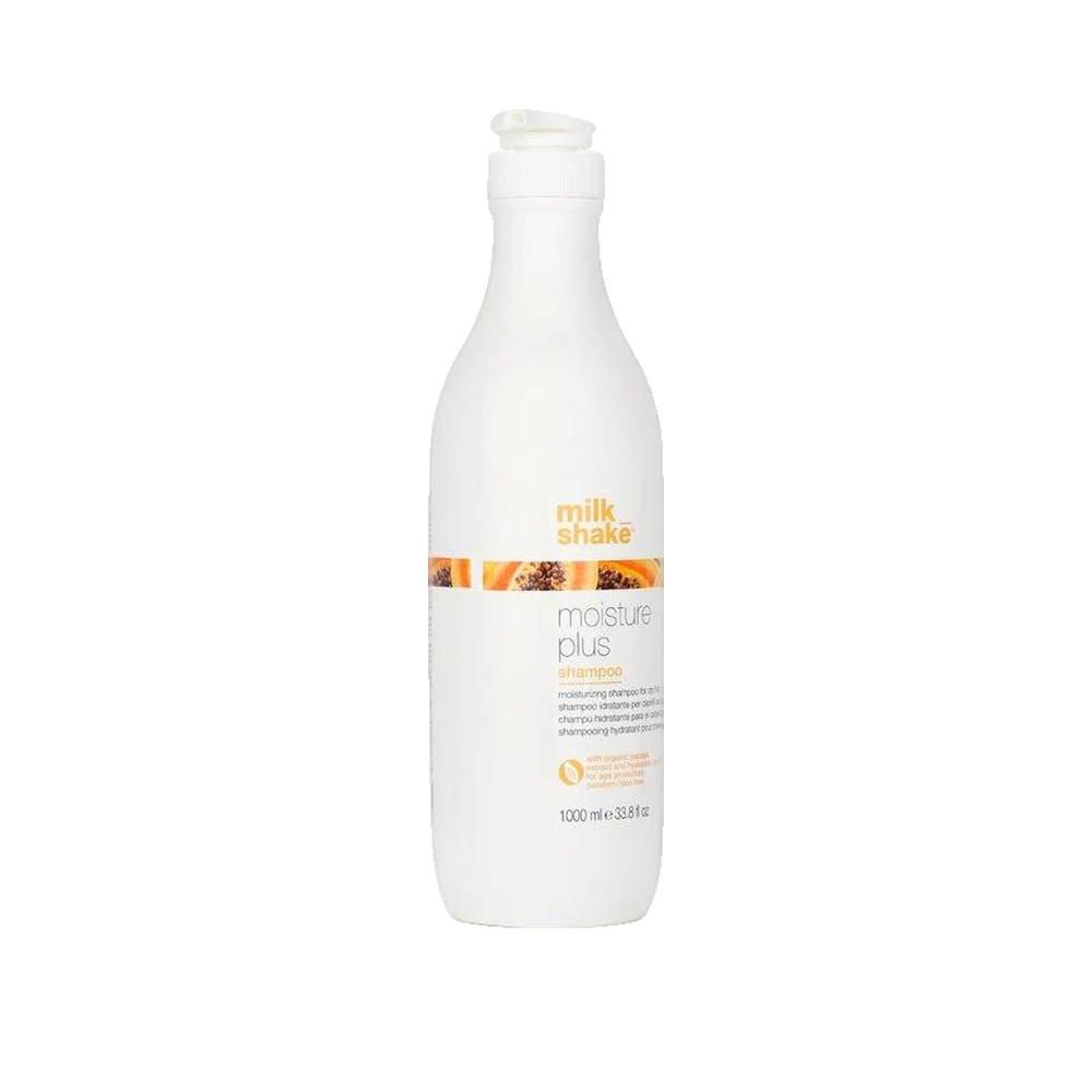 Flacone bianco con dosatore. Scritta: milk_shake, moisture plus shampoo. Striscia arancione con immagine di papaya. 1000 ml.