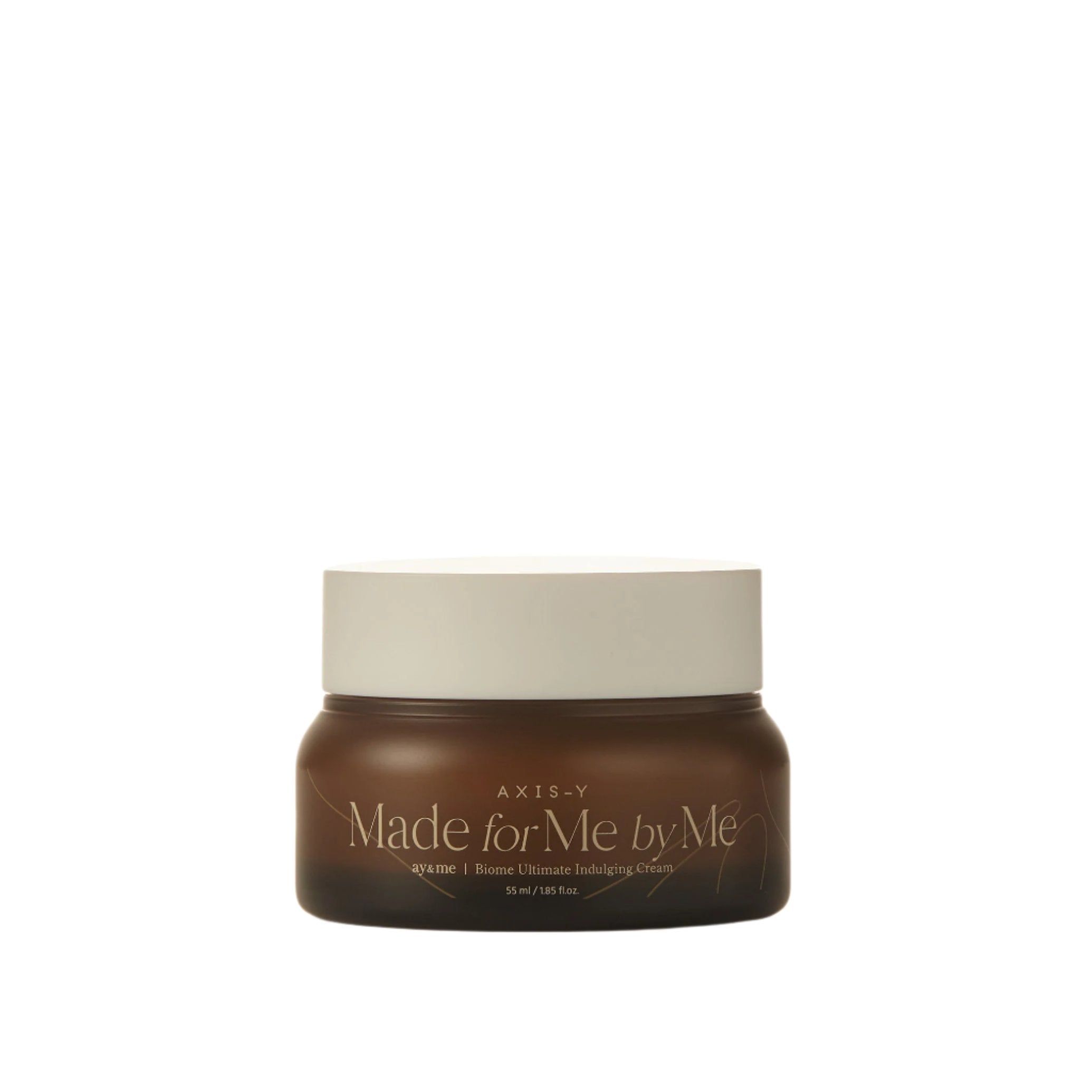 Vaso di crema marrone con coperchio bianco. Scritta: AXIS-Y Made for Me by Me. Biome Ultimate Indulging Cream.