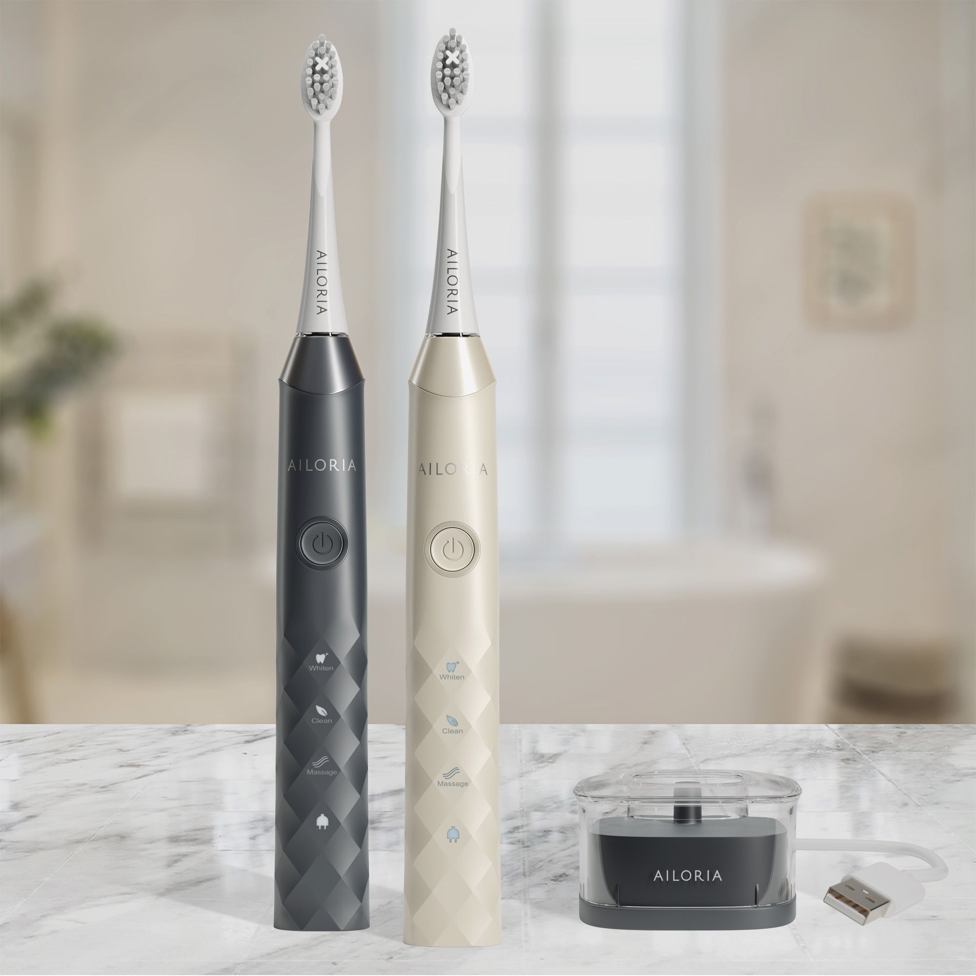 Due spazzolini elettrici, nero e beige, con base di ricarica. Logo AILORIA visibile.