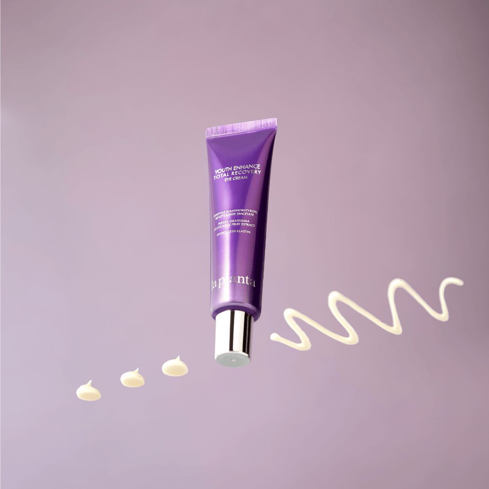 Tubo viola con tappo bianco e tracce di crema. Scritta: YOUTH ENHANCE TOTAL RECOVERY EYE CREAM, la pianta.