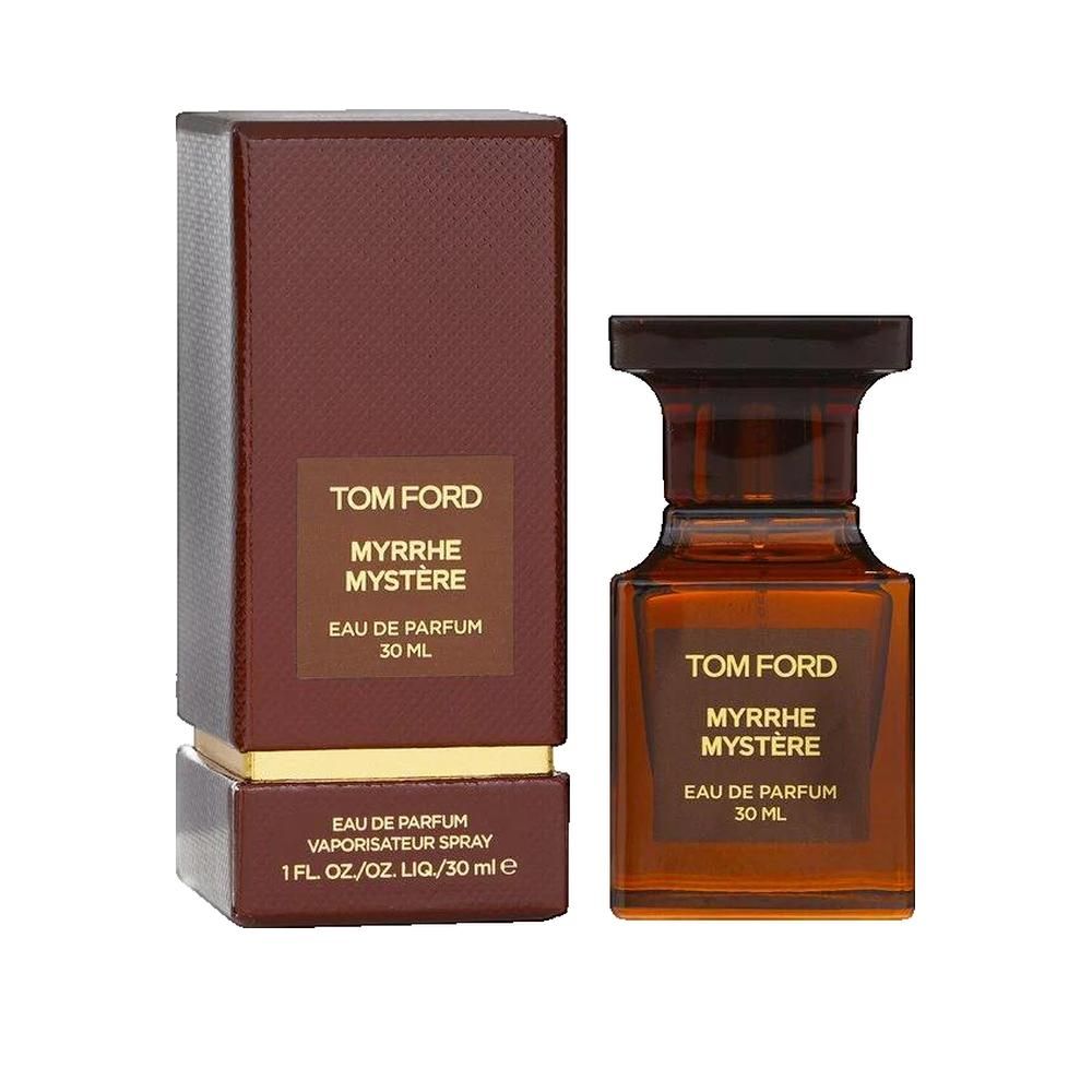 Flacone di profumo marrone accanto alla sua scatola. Scritta: Tom Ford Myrrhe Mystère Eau de Parfum 30 ml.