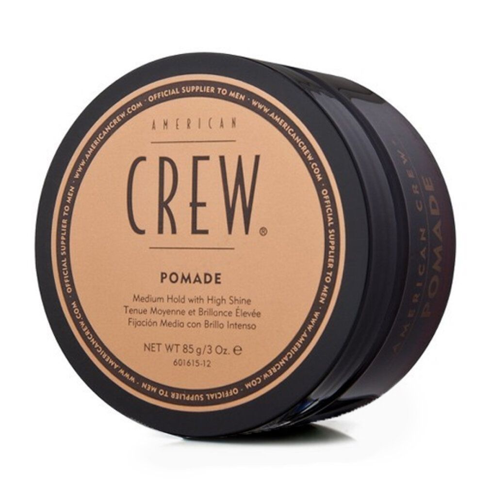 Barattolo nero rotondo con coperchio marrone. Scritta: AMERICAN CREW. Pomade. Netto 85 g/3 Oz.