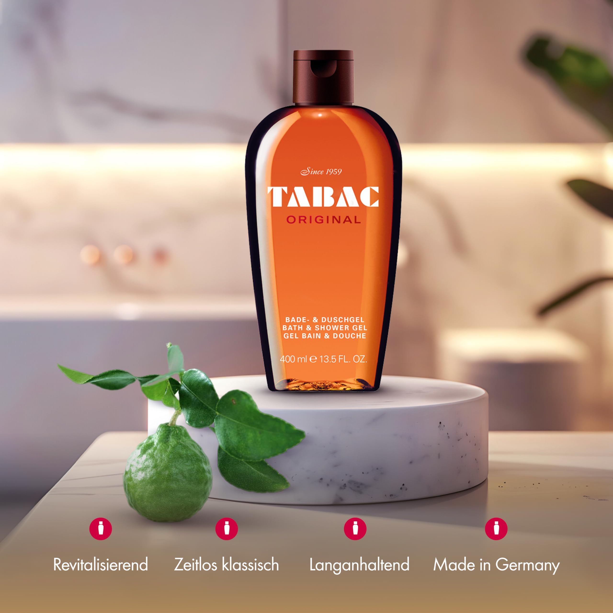 Gel doccia Tabac Original su piedistallo. Foglie e frutto verdi accanto. Testo: Rivitalizzante, Classico senza tempo, Lunga durata, Made in Germany.