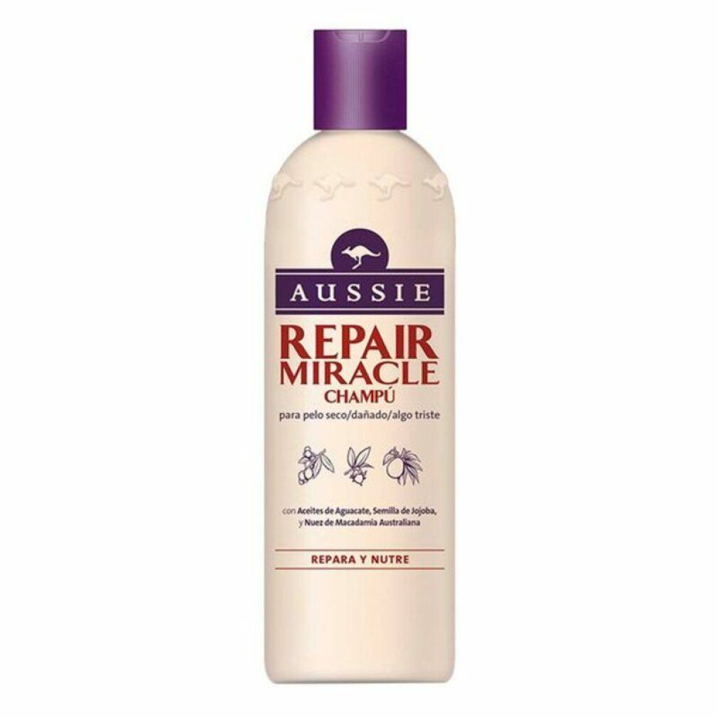 Flacone di shampoo beige con tappo viola. Scritta: Aussie Repair Miracle Champú. Logo canguro.