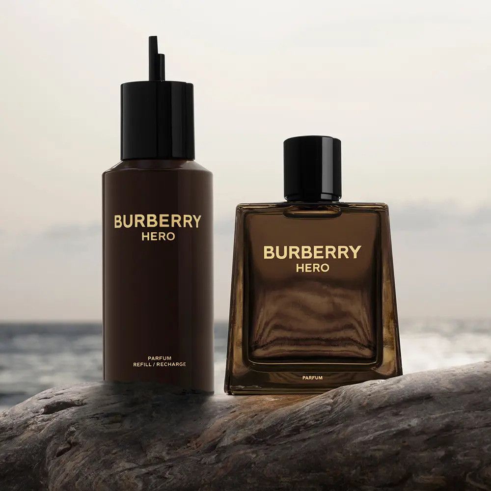 Due flaconi marroni. Uno è allungato, l'altro quadrato. Entrambi portano la scritta BURBERRY HERO.