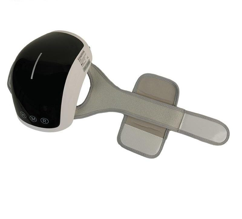 Dispositivo massaggio ginocchio, bianco e nero, con cinturino. Parte superiore curva, parte inferiore con cinturino. Pulsanti H, M, R.