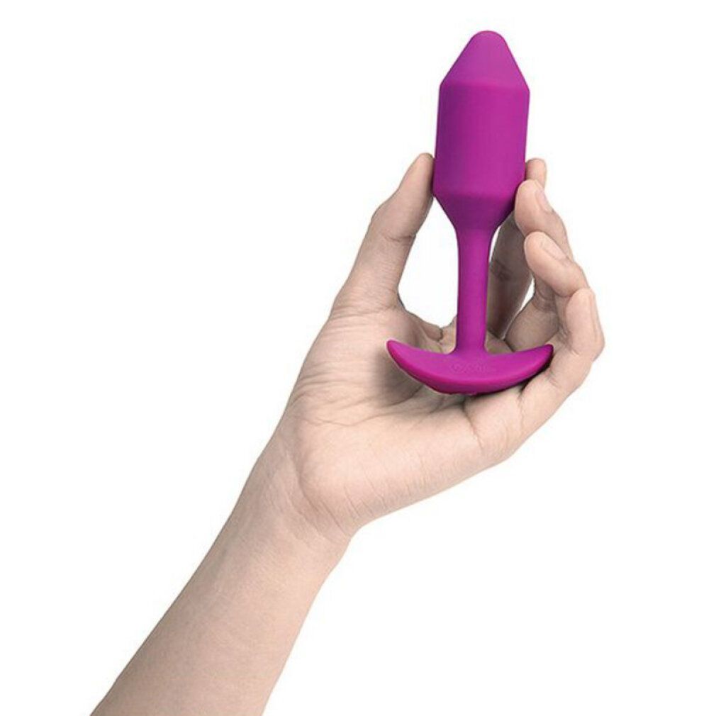 Plug viola tenuto in mano. Punta conica, base a T.