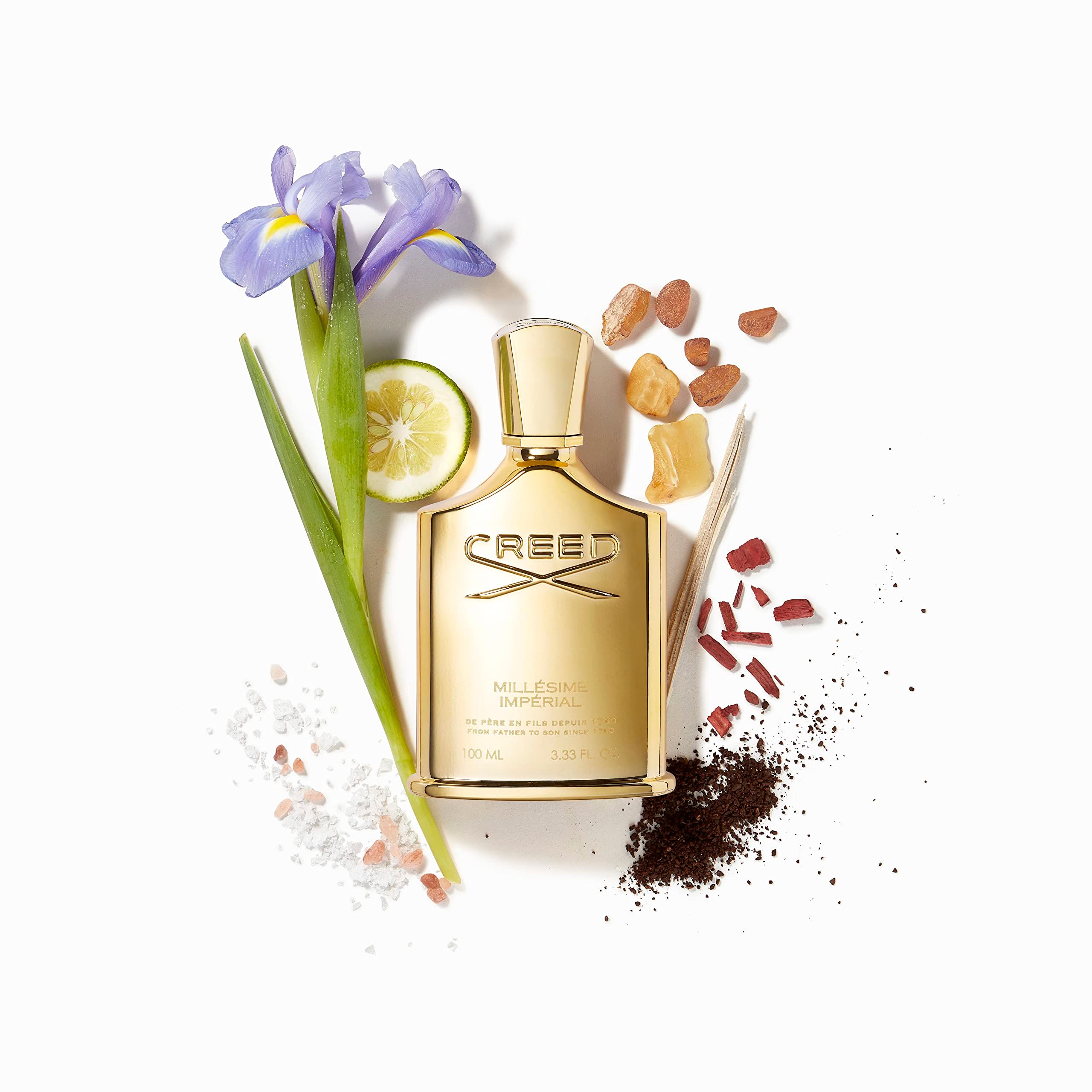 Flacone dorato con ingredienti come limone, fiore, spezie. Scritta CREED MILLÉSIME IMPERIAL.