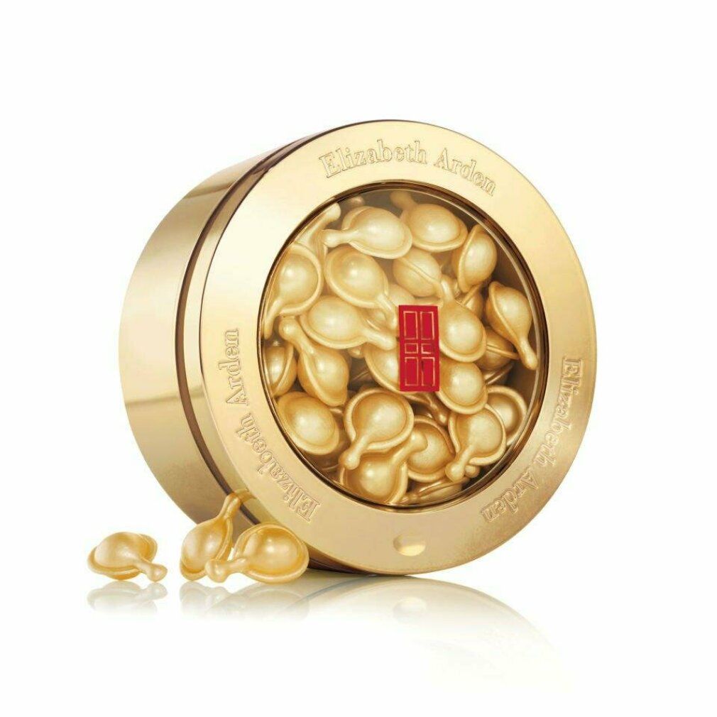 Capsule di siero Elizabeth Arden in scatola dorata. Scatola rotonda con coperchio trasparente. Capsule dorate. Testo: Elizabeth Arden, Advanced Ceramide Capsules.
